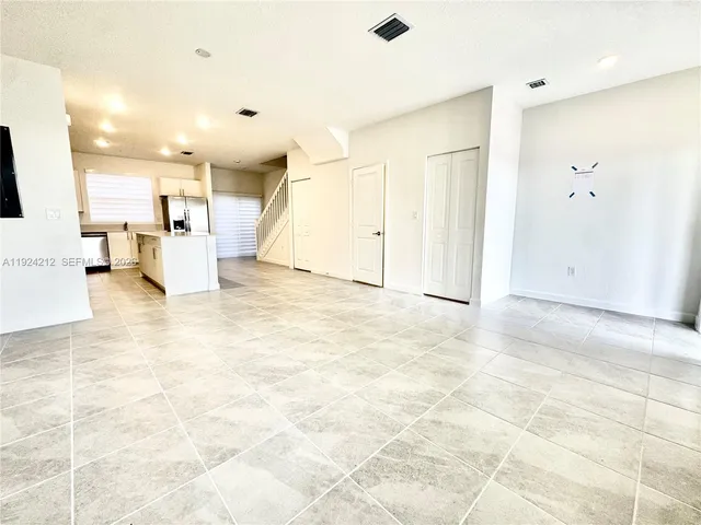 a view of a livingroom with kitchen and furniture