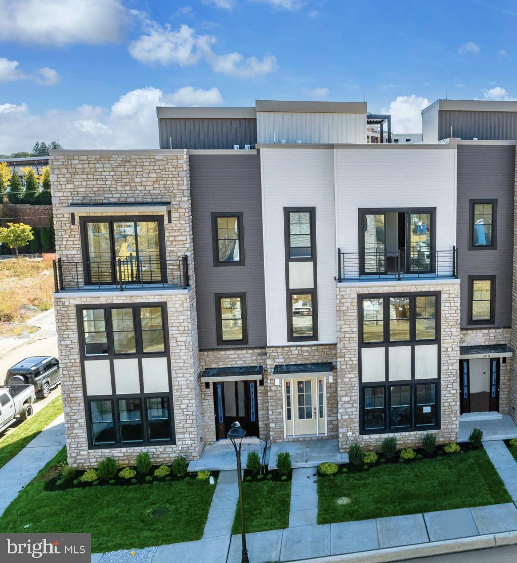 334 Foxtail Lane, Unit 22D Newtown Square, PA 19073 - Photo 1 of 22 a front view of a house with garden