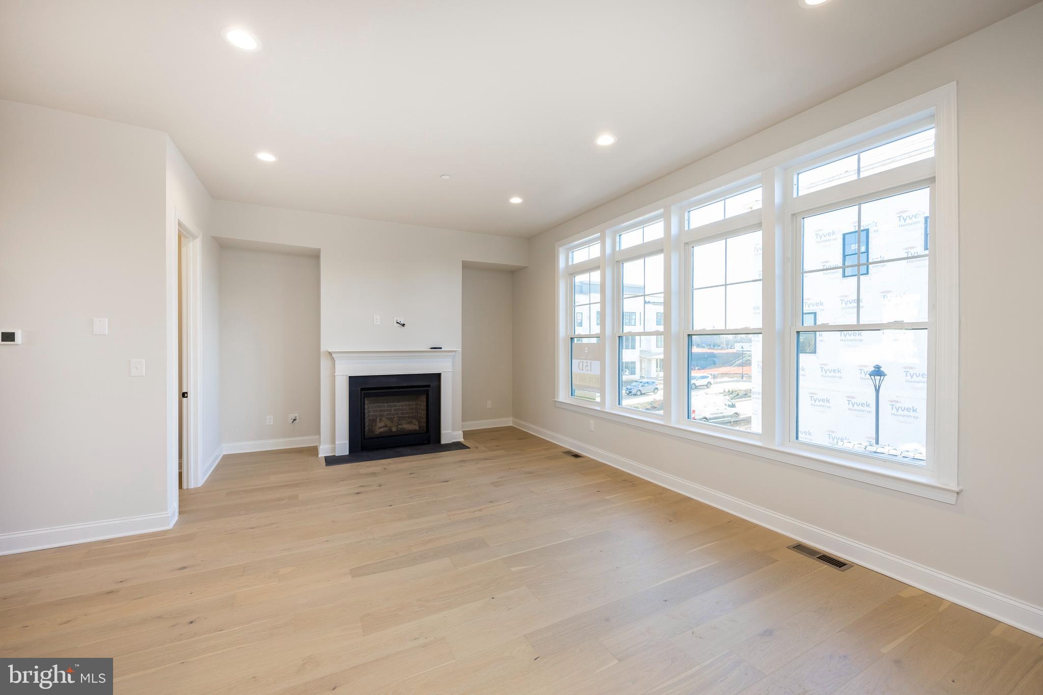 334 Foxtail Lane, Unit 22D Newtown Square, PA 19073 - Photo 16 of 22 an empty room with windows and fireplace