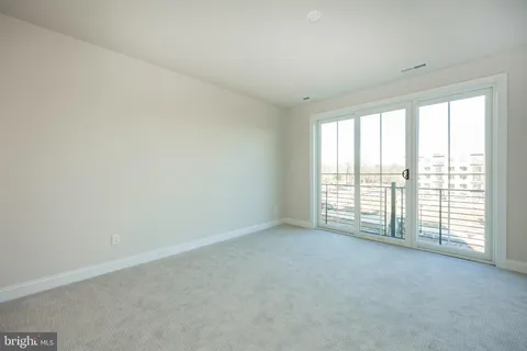 a view of a patio with couches table and chairs and potted plants