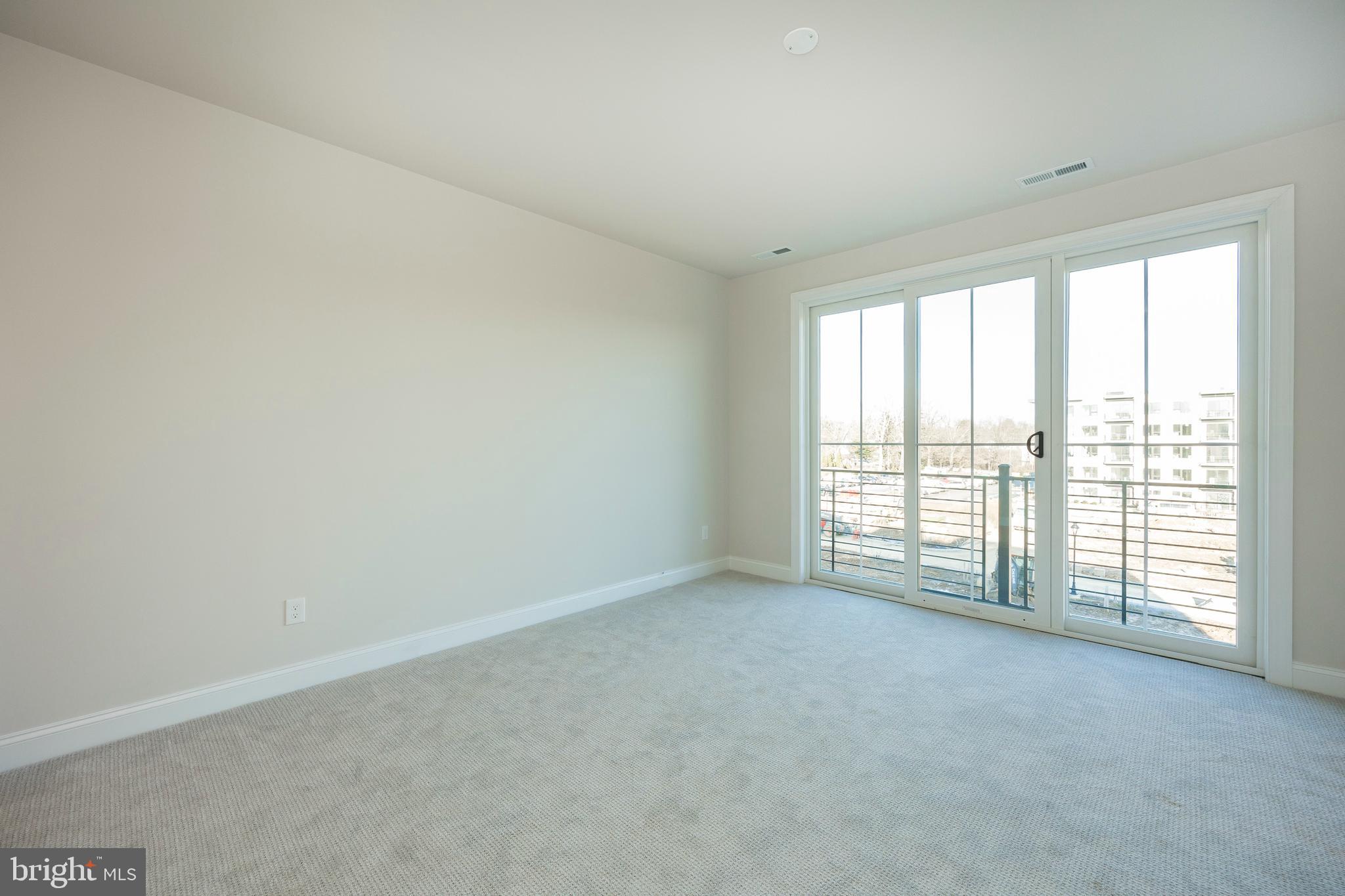 334 Foxtail Lane, Unit 22D Newtown Square, PA 19073 - Photo 18 of 22 a view of an empty room with a window