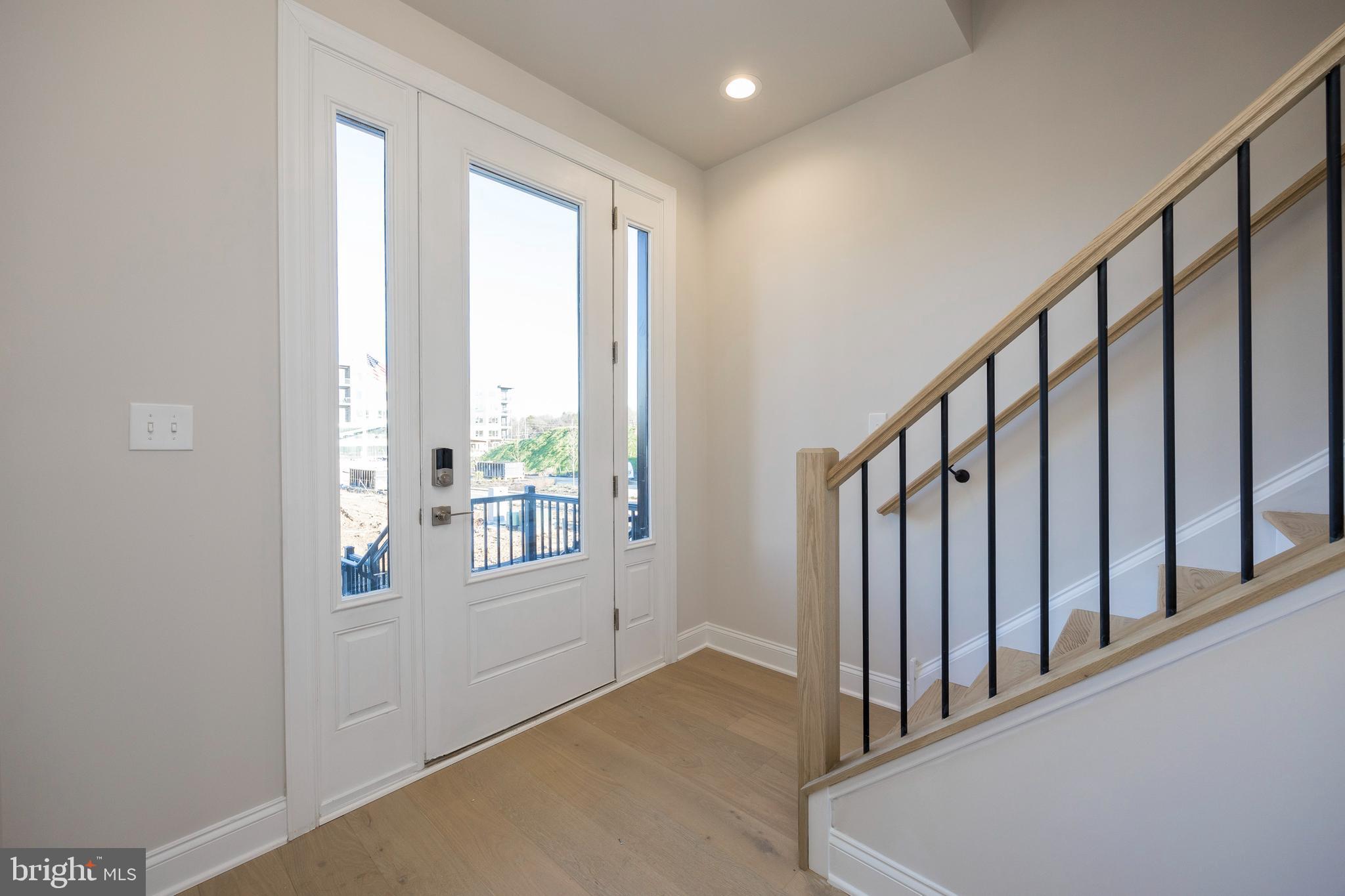 334 Foxtail Lane, Unit 22D Newtown Square, PA 19073 - Photo 2 of 22 a view of an entryway with wooden floor and stairs