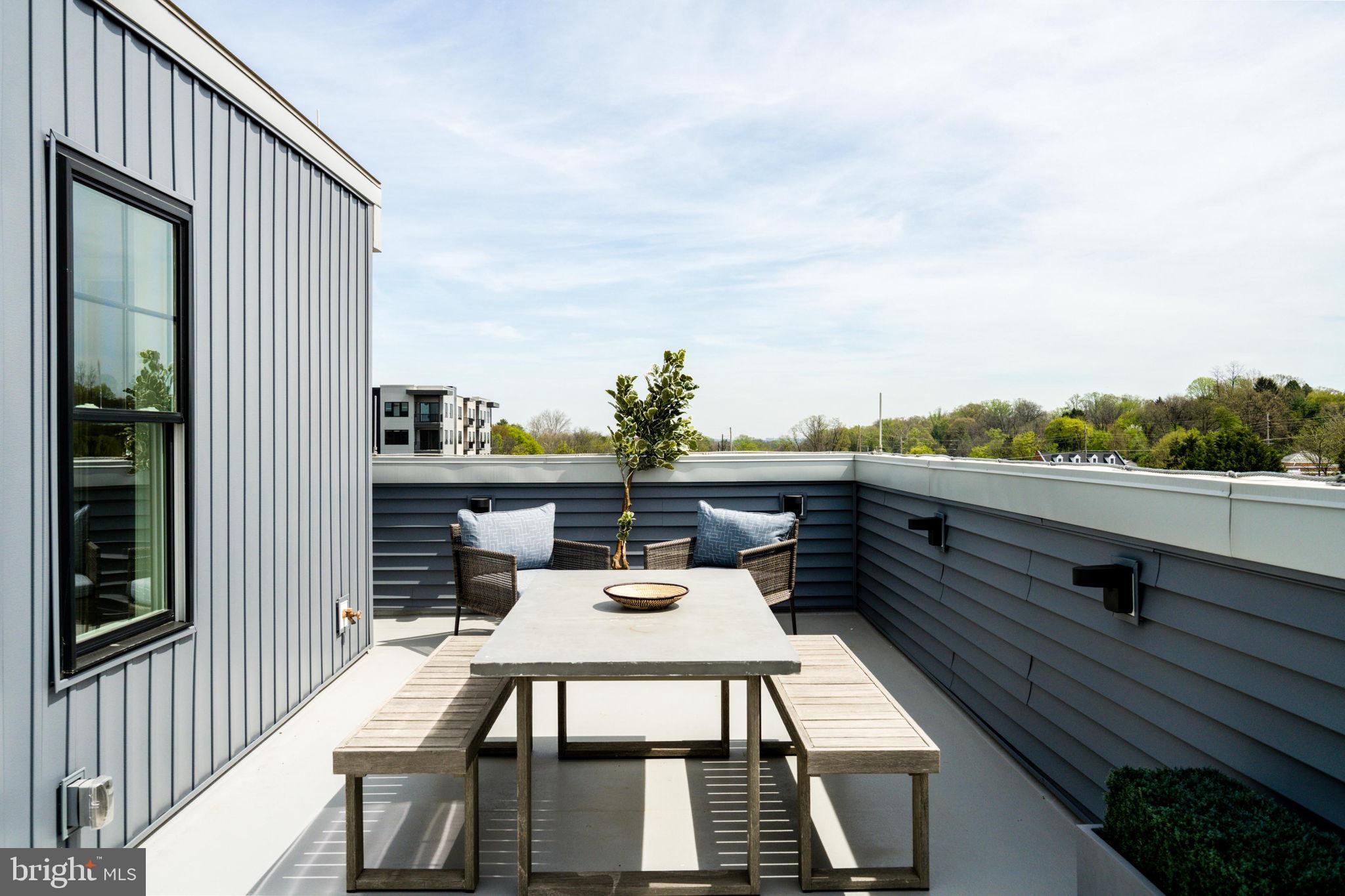 334 Foxtail Lane, Unit 22D Newtown Square, PA 19073 - Photo 22 of 22 a view of a balcony with table and chairs