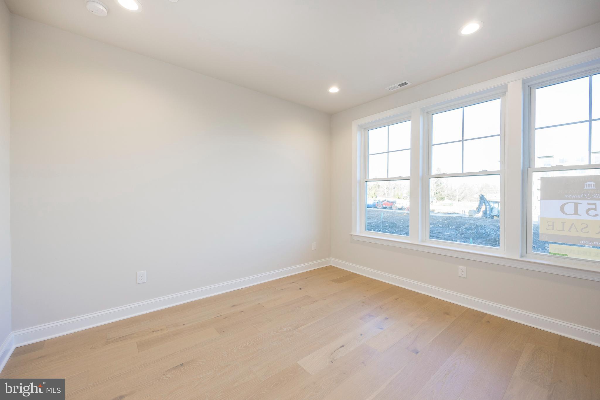 334 Foxtail Lane, Unit 22D Newtown Square, PA 19073 - Photo 4 of 22 an empty room with large windows