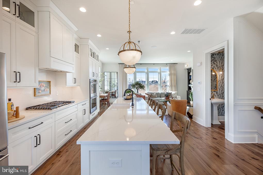 334 Foxtail Lane, Unit 22D Newtown Square, PA 19073 - Photo 7 of 22 a large kitchen with lots of counter space a sink appliances and dining table