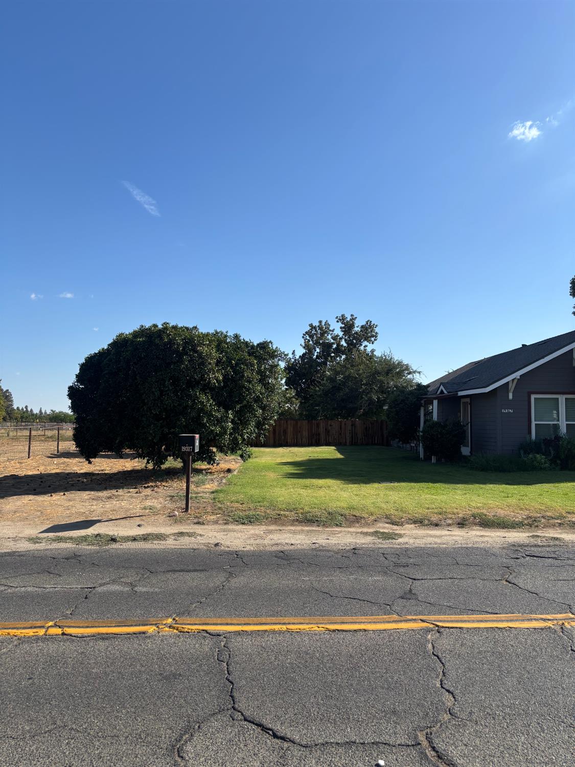 19317 East Parlier Avenue Reedley, CA 93654 - Photo 5 of 36 a view of a yard in front of a house