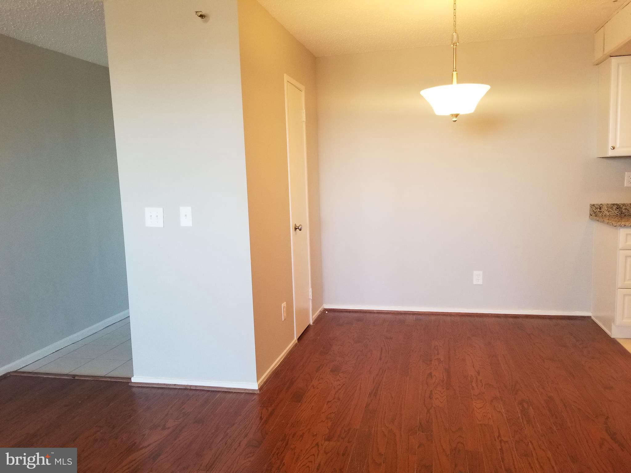 5911 Edsall Road, Unit PH09 Alexandria, VA 22304 - Photo 6 of 14 an empty room with wooden floor and windows