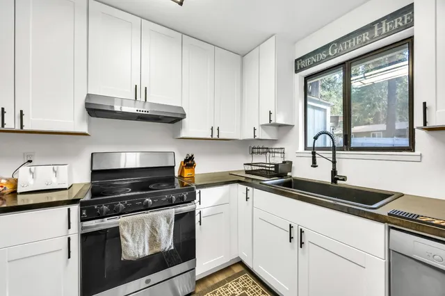 a view of a hallway with wooden floor and closet