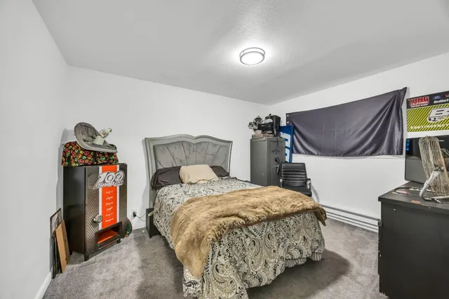 a bedroom with a bed and a cabinet