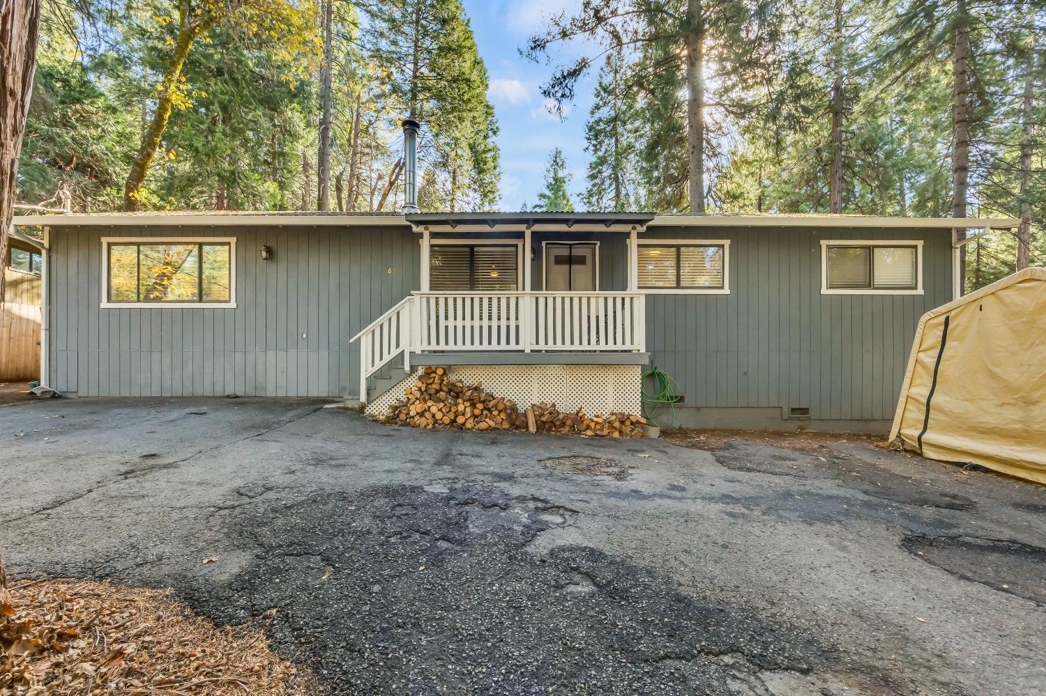 6922 Ridgeway Drive Pollock Pines, CA 95726 - Photo 2 of 44 front view of a house with a large tree