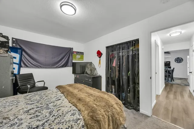 a bedroom with a bed and a window