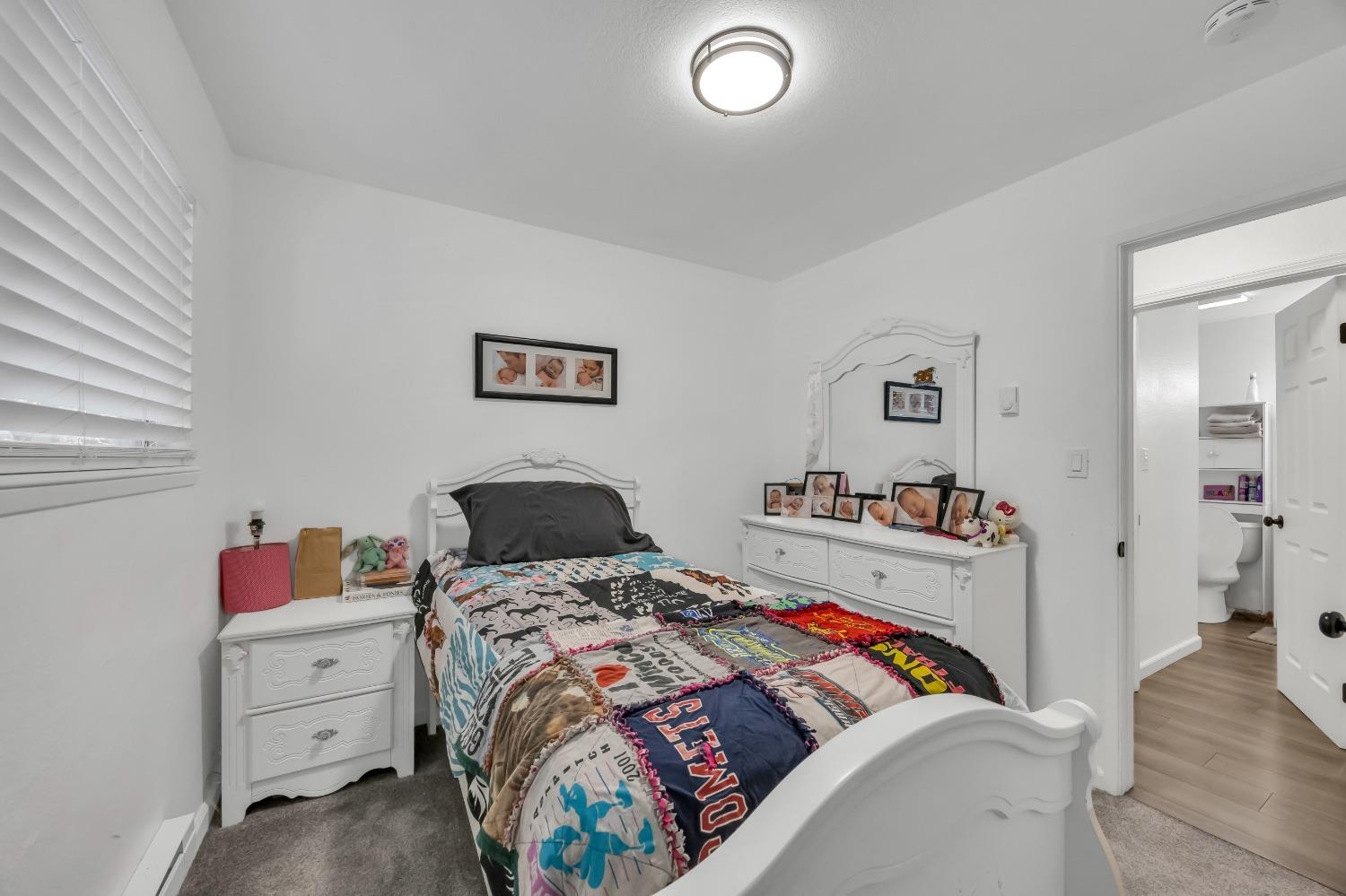 6922 Ridgeway Drive Pollock Pines, CA 95726 - Photo 23 of 44 a bedroom with a bed and wooden floor
