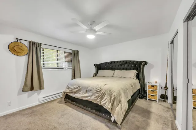 a bedroom with a bed and a large mirror