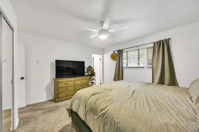 a bathroom with a sink a toilet and shower curtain