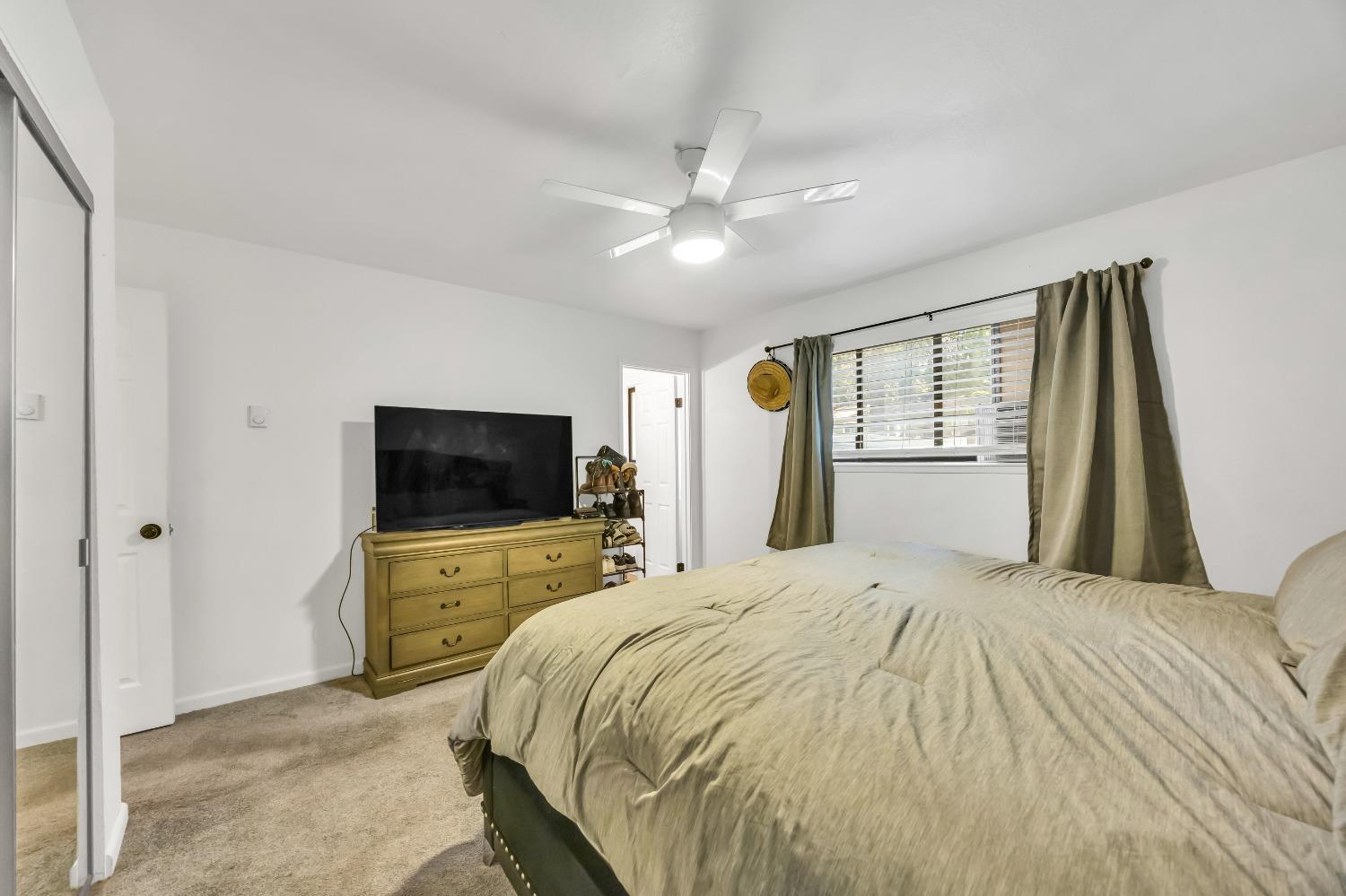 6922 Ridgeway Drive Pollock Pines, CA 95726 - Photo 27 of 44 a bedroom with a bed and a flat screen tv