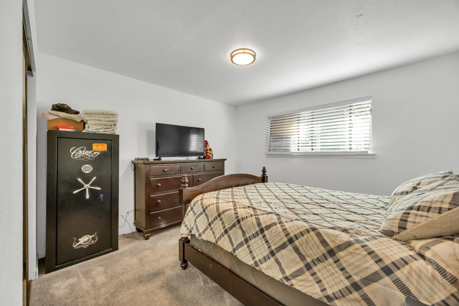 6922 Ridgeway Drive Pollock Pines, CA 95726 - Photo 30 of 44 a bedroom with a bed and a television