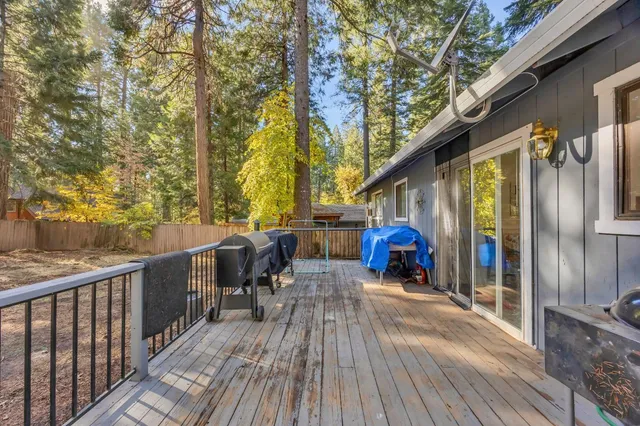 a view of a deck with chairs and wooden floor