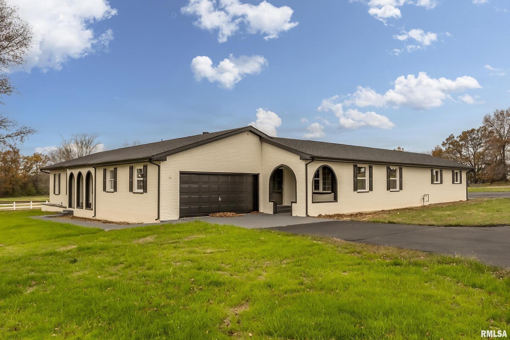 7837 Highway 37 Benton, IL 62812 - Photo 12 of 37 a front view of house with yard and trees in the background