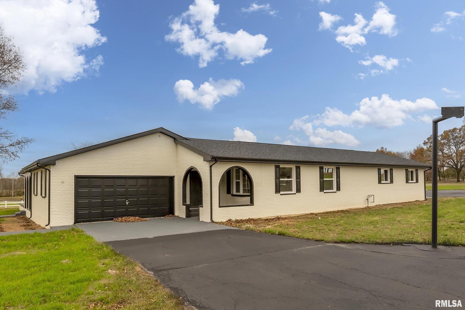 7837 Highway 37 Benton, IL 62812 - Photo 15 of 37 a front view of a house with a yard and garage