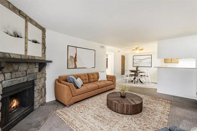 a living room with furniture a window and a fireplace