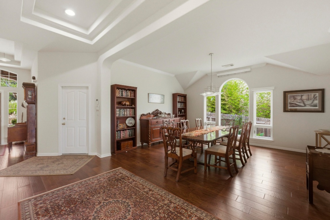 4705 Foster Ranch Road Austin, TX 78735 - Photo 12 of 40 a view of a dining room with furniture window and wooden floor