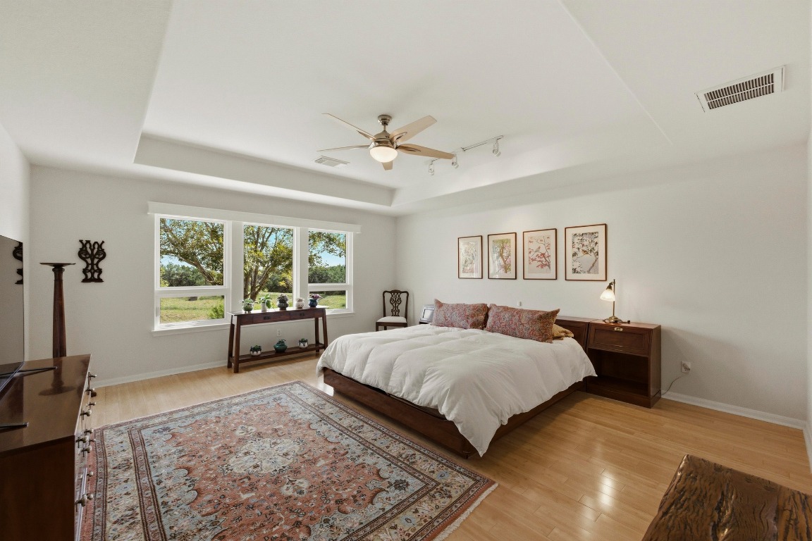 4705 Foster Ranch Road Austin, TX 78735 - Photo 14 of 40 a spacious bedroom with a bed and a large window with outer view