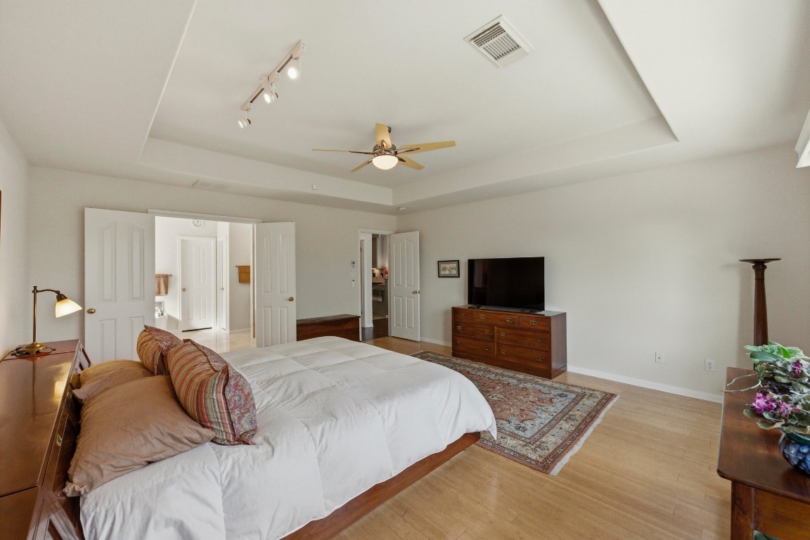 4705 Foster Ranch Road Austin, TX 78735 - Photo 15 of 40 a bedroom with a bed and a flat screen tv