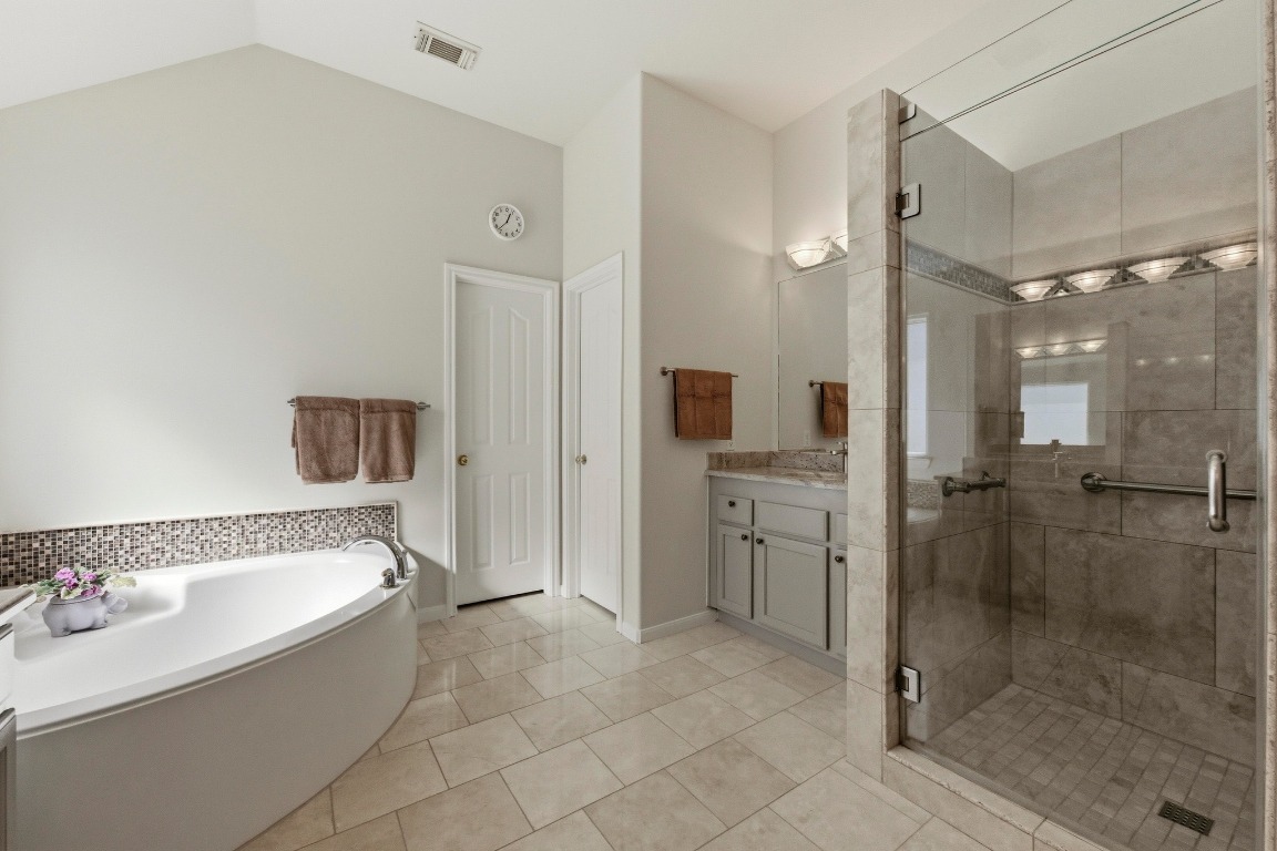 4705 Foster Ranch Road Austin, TX 78735 - Photo 17 of 40 a bathroom with a bathtub and a shower