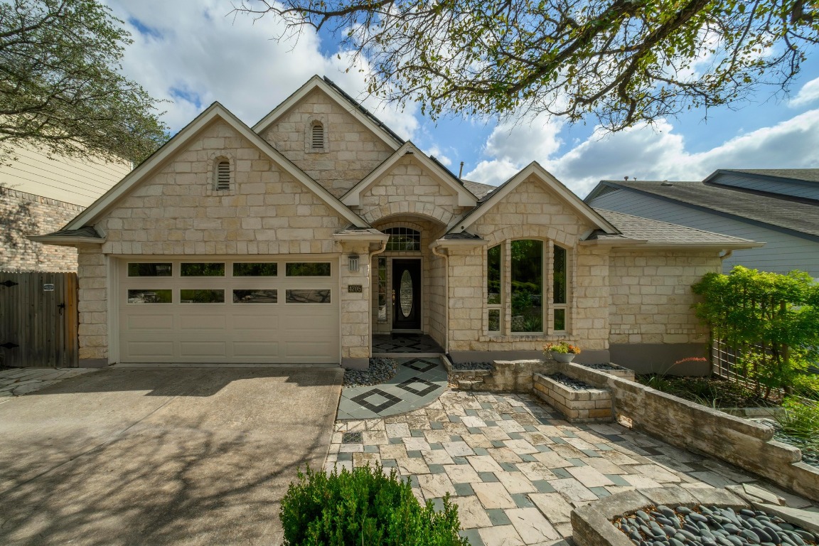 4705 Foster Ranch Road Austin, TX 78735 - Photo 33 of 40 a front view of a house with a yard and garage