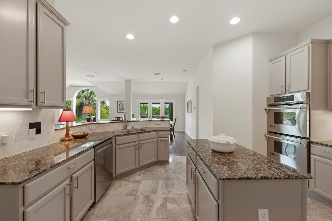 4705 Foster Ranch Road Austin, TX 78735 - Photo 9 of 40 a kitchen with stainless steel appliances granite countertop a sink stove and refrigerator