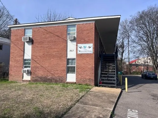 a brick building with a street sign on the side of it