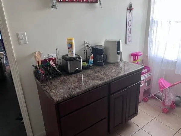 a kitchen with granite countertop a cabinets and a stove