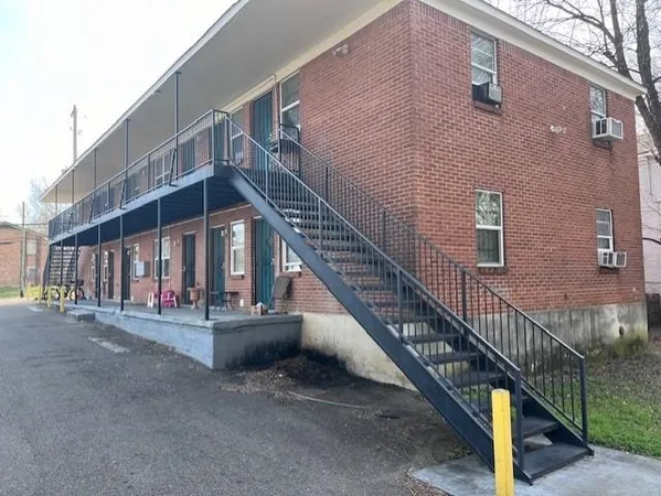 a view of a house with stairs and a street
