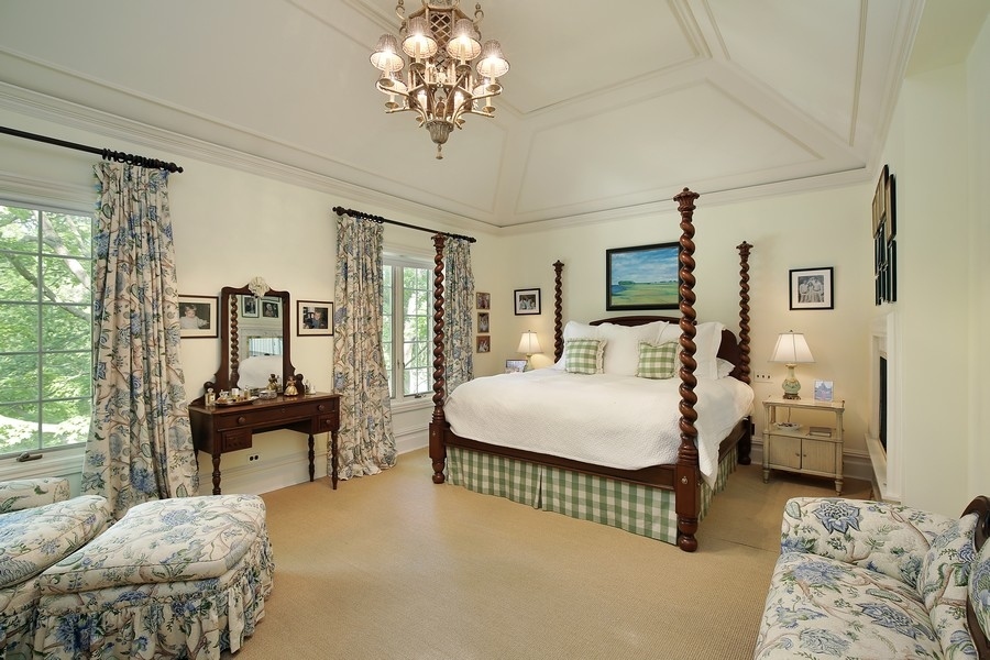 641 Briar Lane Northfield, IL 60093 - Photo 17 of 35 a bedroom with a bed and a chandelier