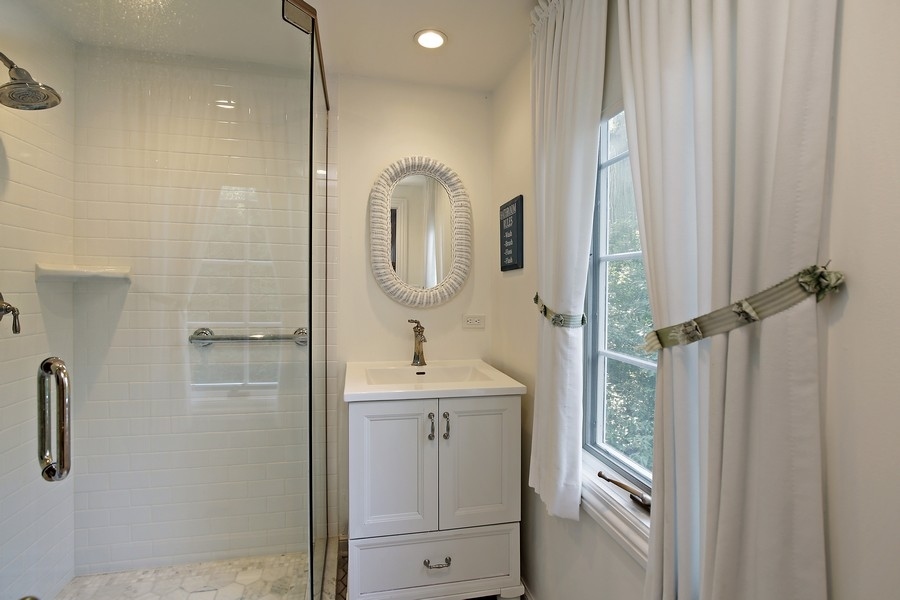 641 Briar Lane Northfield, IL 60093 - Photo 26 of 35 a bathroom with a sink a mirror and shower