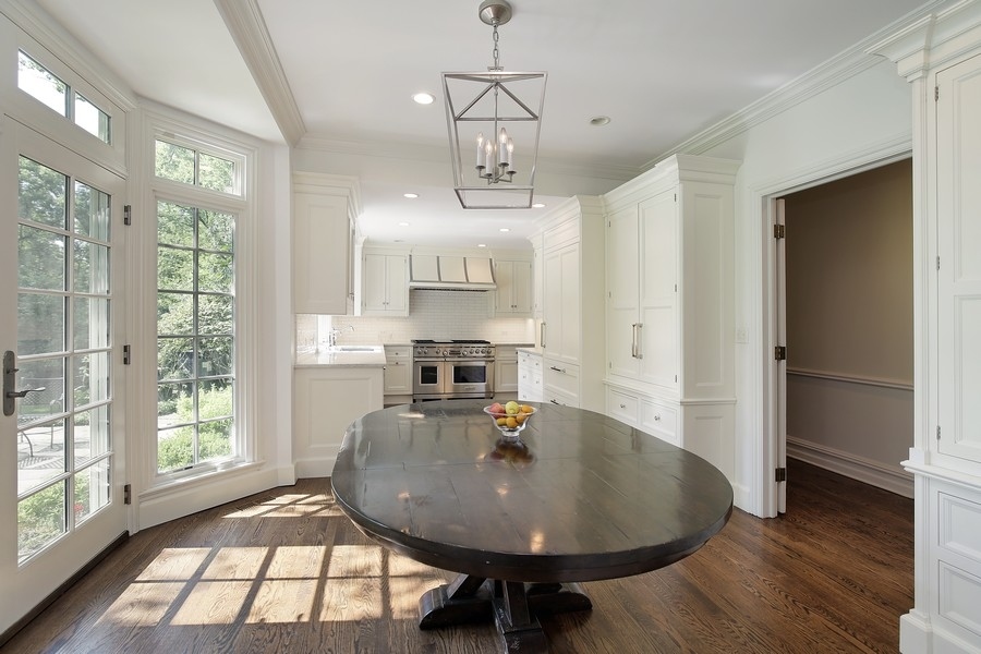 641 Briar Lane Northfield, IL 60093 - Photo 10 of 35 a dining room with wooden floor a chandelier a glass table and chairs