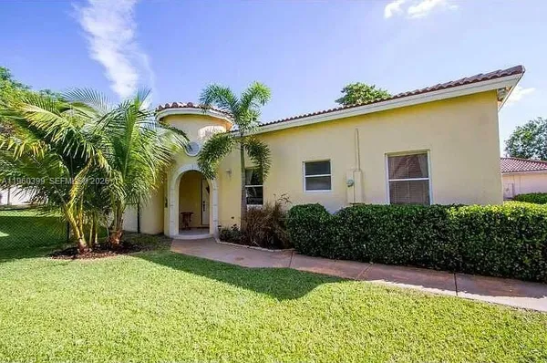a front view of house with yard and entertaining space