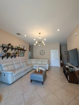 a living room with furniture and a chandelier
