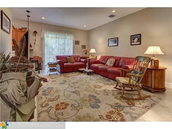 a living room with furniture and a gym