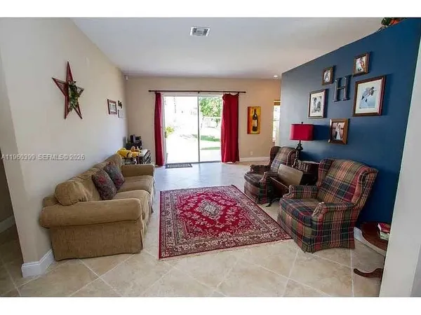 a living room with furniture and a flat screen tv