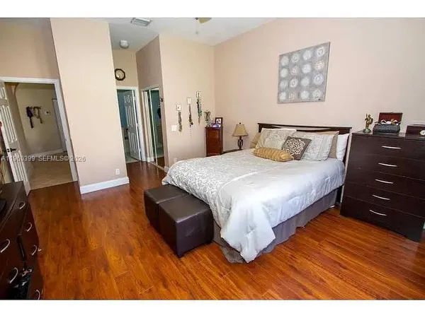 a bedroom with a bed window and a flat screen tv