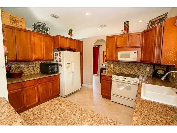 a kitchen with a sink stove and cabinets