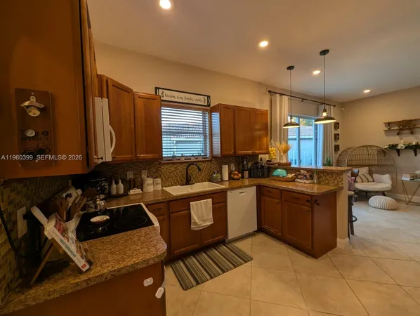 a kitchen with a stove and a chandelier