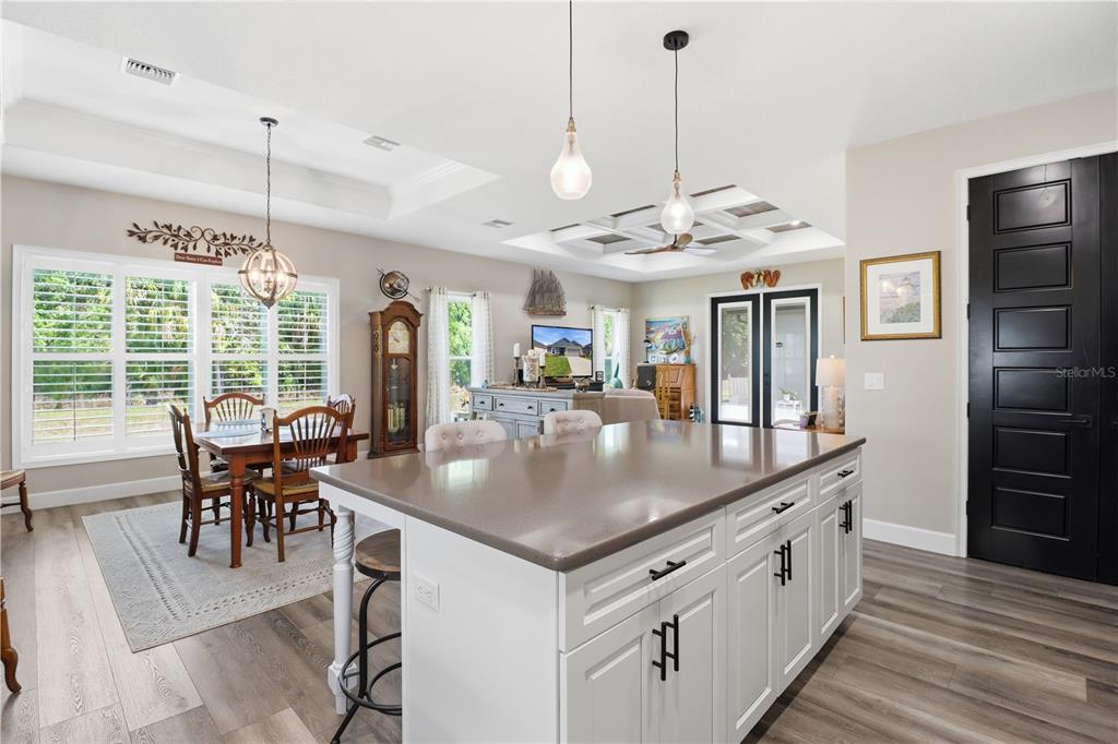 9689 East White Egret Path Inverness, FL 34450 - Photo 13 of 44 a kitchen with stainless steel appliances granite countertop a stove a refrigerator a kitchen island a dining table and chairs