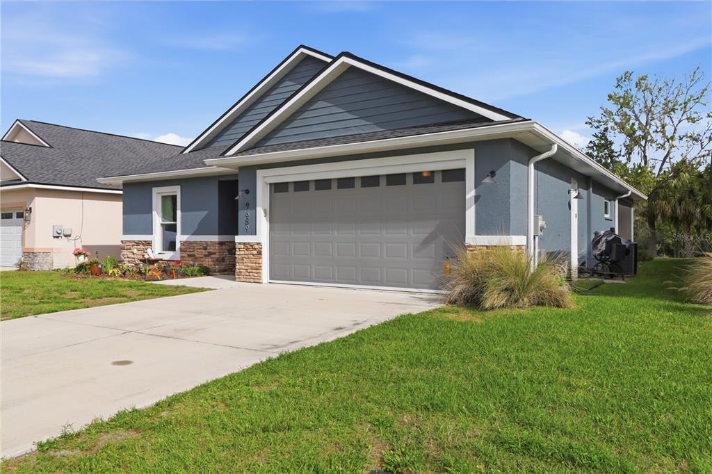 9689 East White Egret Path Inverness, FL 34450 - Photo 2 of 44 a front view of a house with a yard and garage