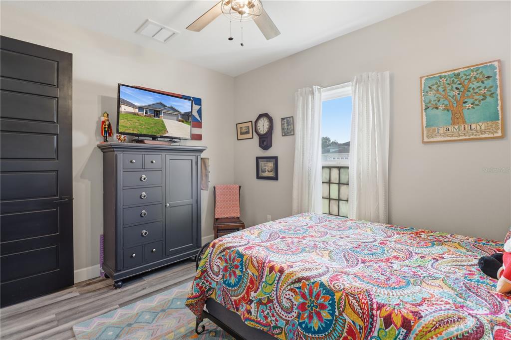 9689 East White Egret Path Inverness, FL 34450 - Photo 22 of 44 a bedroom with a bed and a dresser