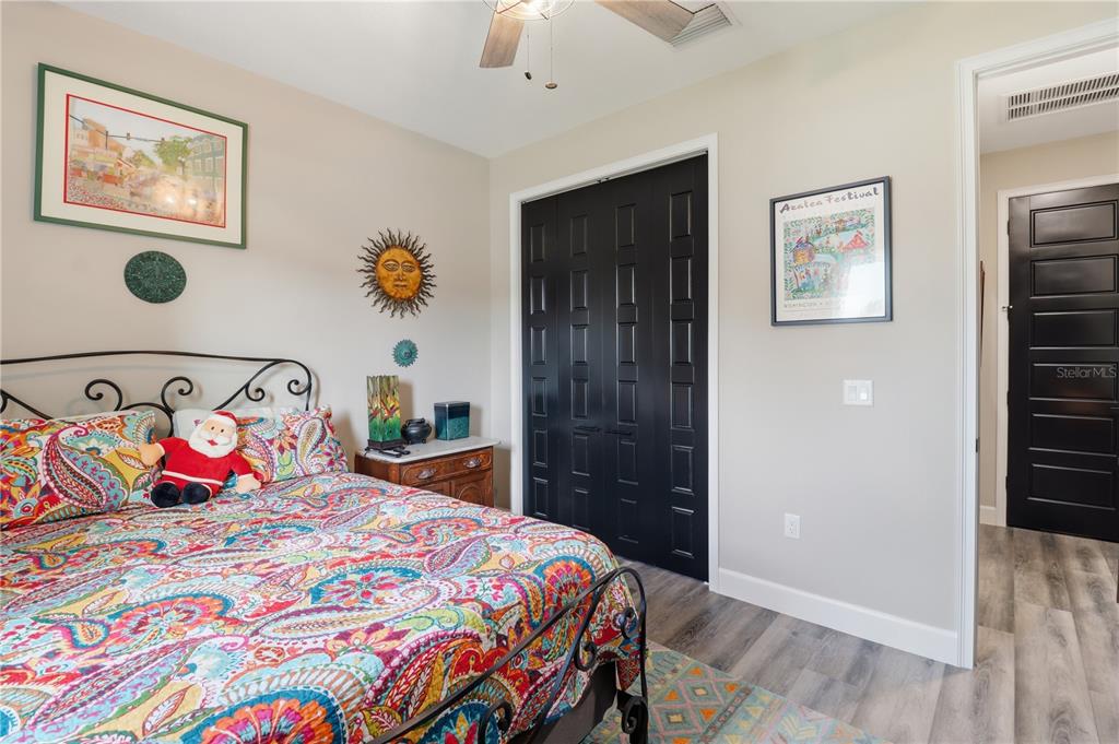 9689 East White Egret Path Inverness, FL 34450 - Photo 23 of 44 a bedroom with a bed and a chandelier