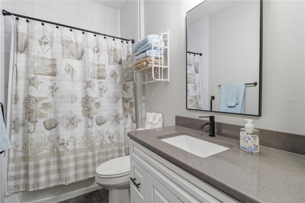 9689 East White Egret Path Inverness, FL 34450 - Photo 24 of 44 a bathroom with a granite countertop sink a toilet and a mirror