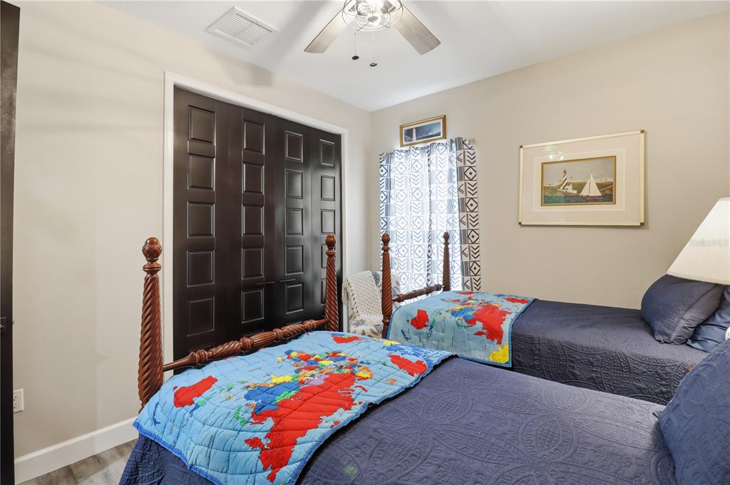 9689 East White Egret Path Inverness, FL 34450 - Photo 27 of 44 a bedroom with a bed and a chandelier