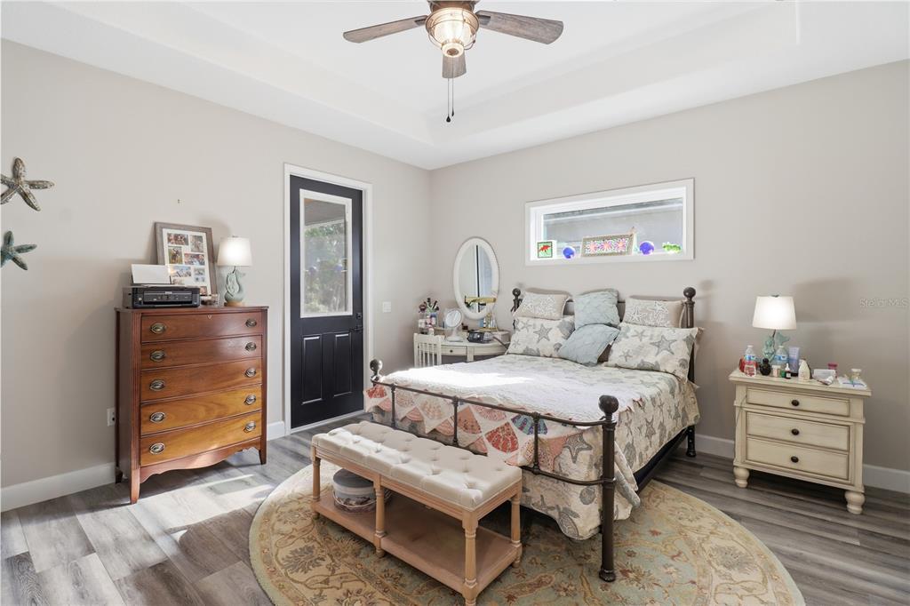 9689 East White Egret Path Inverness, FL 34450 - Photo 28 of 44 a bedroom with a bed and a chandelier